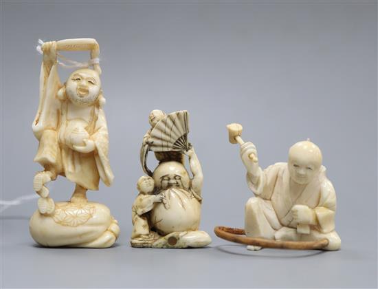 Three Japanese ivory netsuke of Daruma and two men, Hotei and a craftsman, Meiji-Taisho period